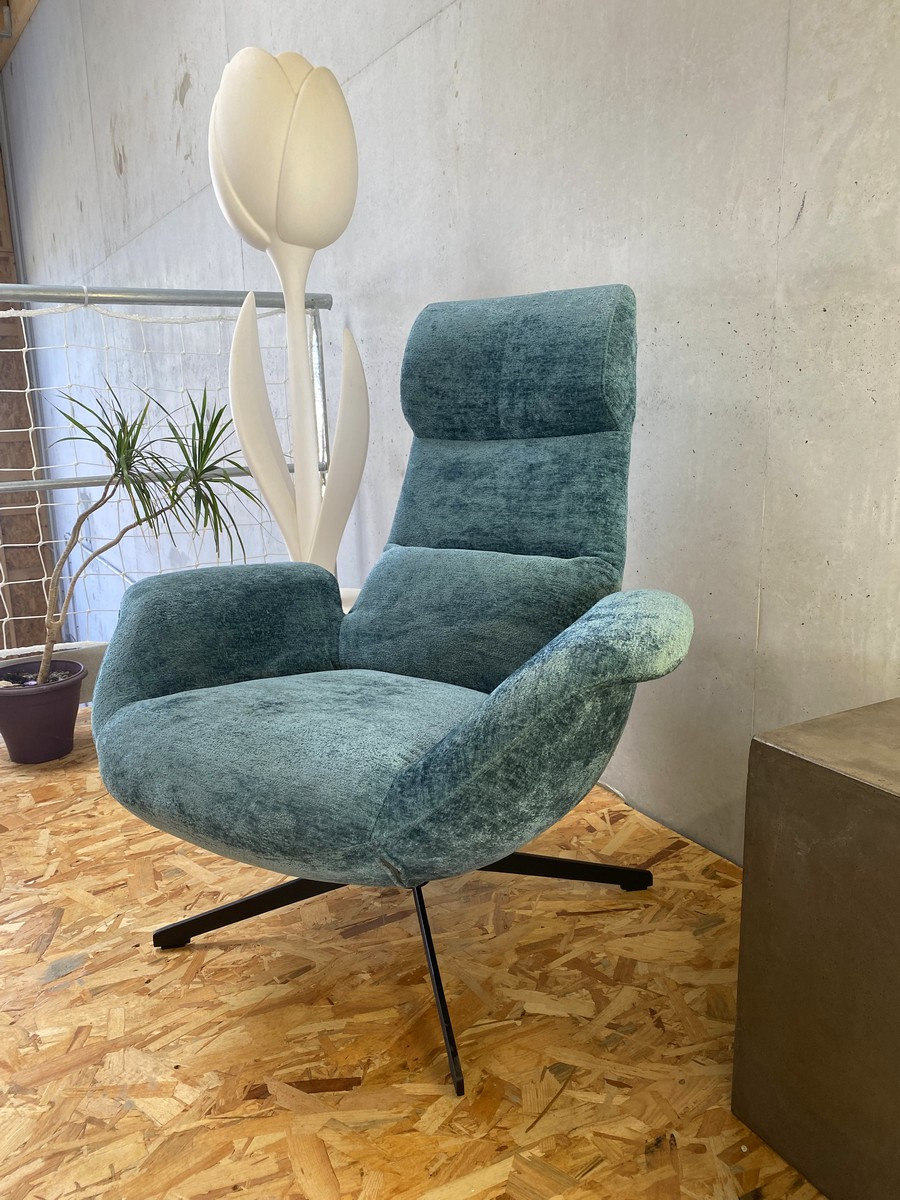 Blue velvet wivel armchair